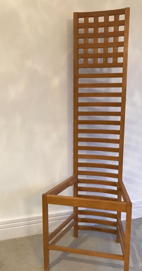 A tall-backed oak chair after a Charles Rennie Mackintosh design, made by hand by Mike Lambert as an apprentice.